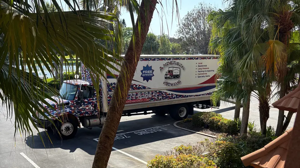 Andersen Moving marked truck with visible registration and service list on a Treasure Coast street, an example of a legitimate, verifiable Florida mover.