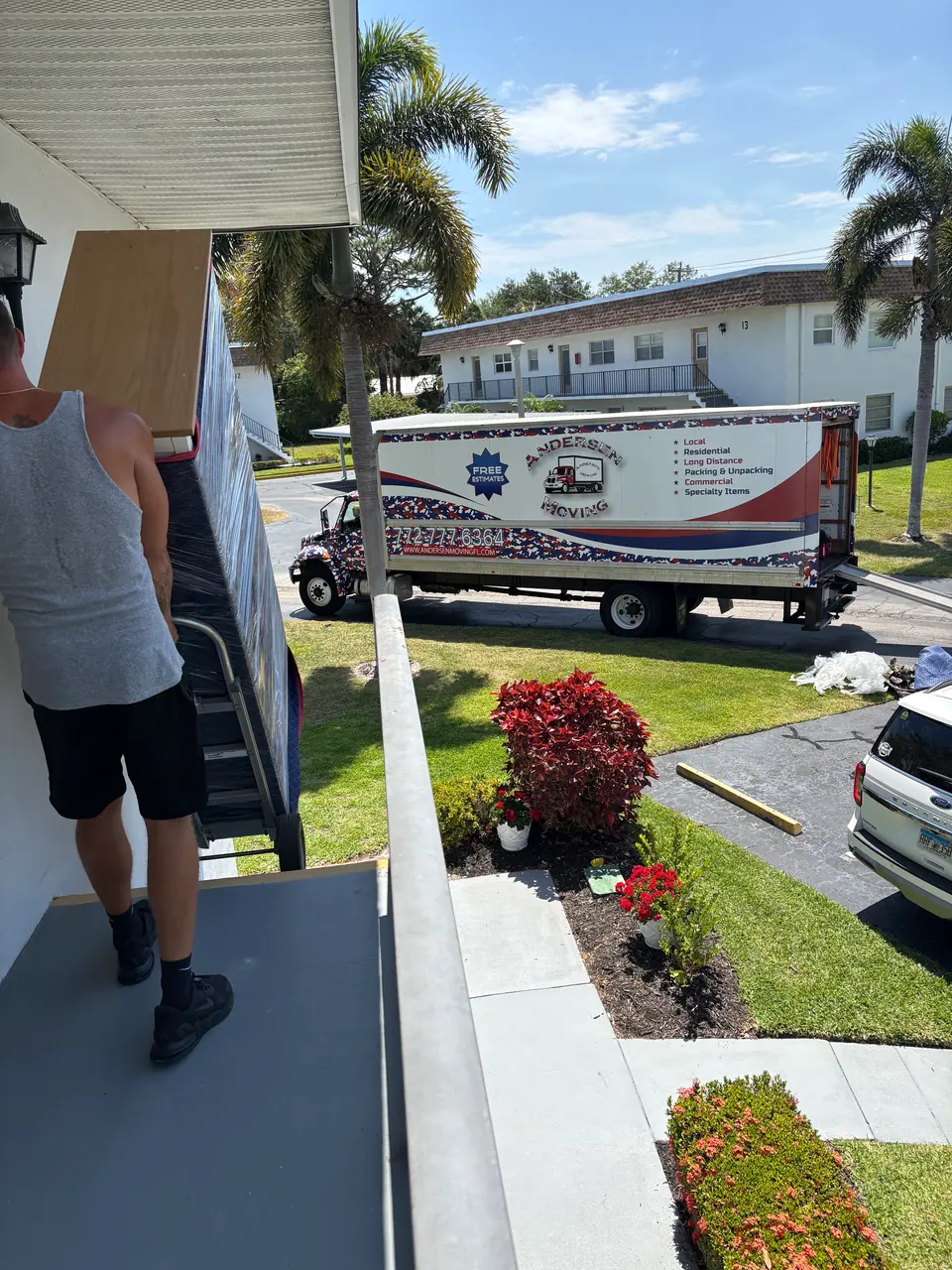 Andersen Moving crew carrying furniture at a Jupiter residence
